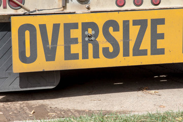 Close up of the oversize sign on the back of a semi truck