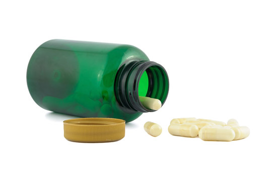 Pills falling out from green jar