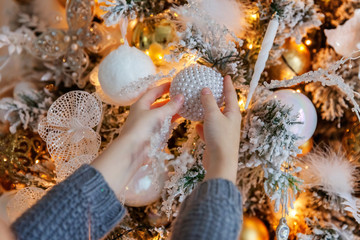 Young girl decorating Christmas tree