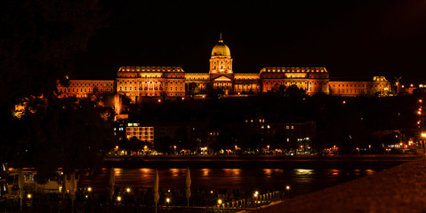 Cityscape of Budapest with Buda castle reflecting in Danube river. Night scene in Budapest