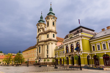 Eger main square in Hungary, Europe with dark moody sky and catholic cathedral. Travel outdoor european background