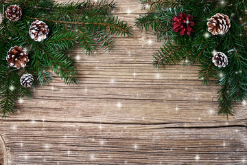 Christmas background. Christmas fir tree branch with decoration. Copy space, top view, toned