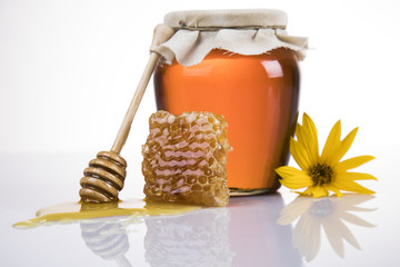 Jar of honey with honeycomb