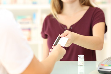 Customer giving credit card in a pharmacy