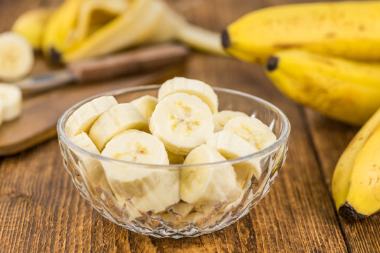 Wooden table with Sliced Bananas, selective focus