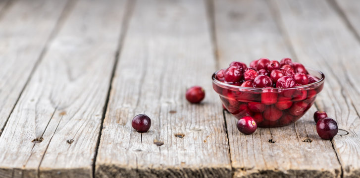 Some fresh Cranberries (preserved) (selective focus; close-up shot)