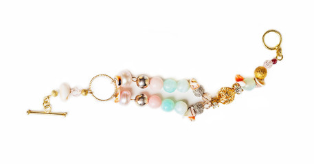 gold jewerly braslete with semiprecious at white background