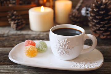 Christmas drink: coffee, colorful candy and  burning candles