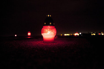 light on the grave at November night