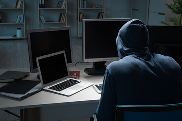 Hacker hacking computer at night