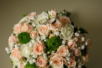 Wedding rings of bride and groom on wedding bouquet