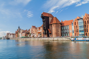 GDANSK, POLAND - SEPTEMBER 2, 2016: Riverside houses by Motlawa river in Gdansk, Poland. Medieval crane in the background.