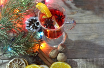 christmas hot mulled wine with cinnamon cardamom and anise on wooden background