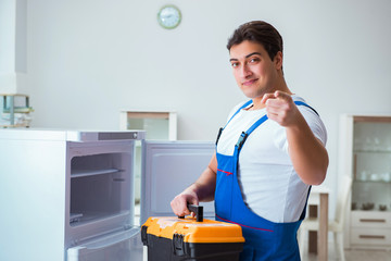 Repairman contractor repairing fridge in DIY concept