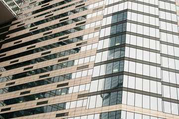 Fototapeta premium Modern glass building business center. Skyscraper in the city. The sun's rays are reflected in the glass surface of the building. Bottom view.