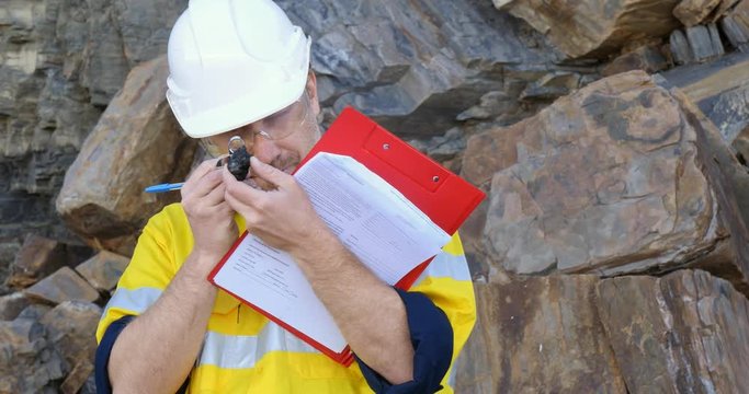 Geochemist Geologist taking field notes about geology in mineral exploration