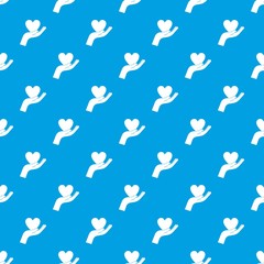 Hand holding heart pattern seamless blue