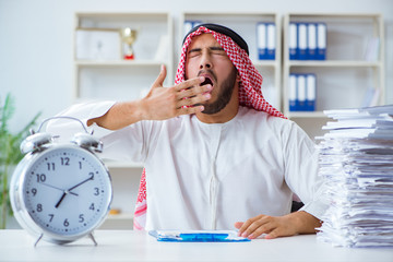 Arab businessman working in the office doing paperwork with a pi
