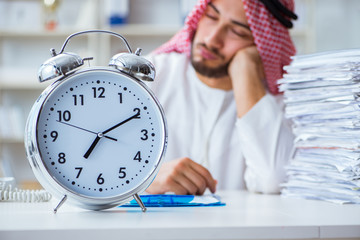 Arab businessman working in the office doing paperwork with a pi