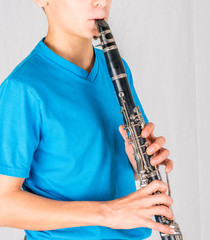 Fototapeta premium Close-up photo of clarinet in the hands of boy
