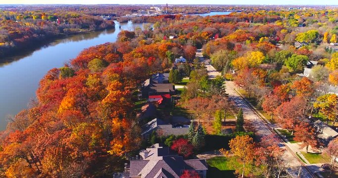 Amazing colorful Autumn trees along riverside, small town, Wisconsin.
