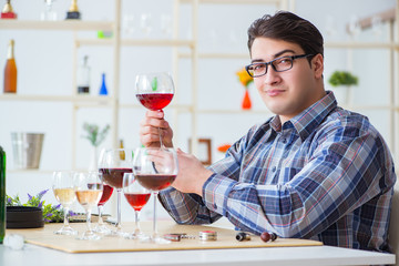 Professional sommelier tasting red wine 