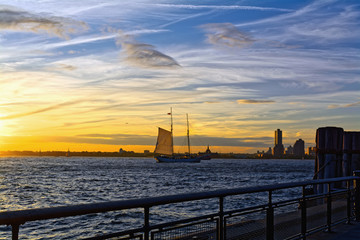 River Hudson in New York City, USA at sunset, with Ellis Island and Jersey City in the background.