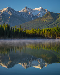 Snowy Mountains Reflect in Peaceful Lake