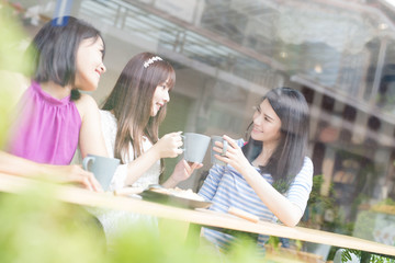 happy woman friends in restaurant