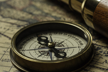 Retro compass with old map and spyglass