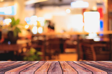  texture of brown wood floor and blur of coffee shop  behind for background.
