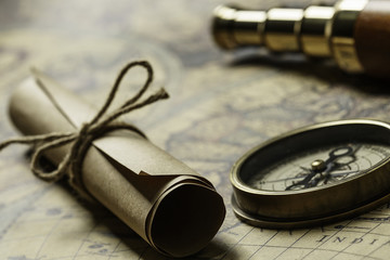 Retro compass with old map and spyglass