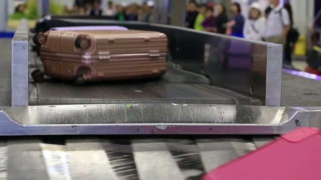 Baggage conveyor belt in airport carrying the passenger luggage. Bangkok, Thailand
