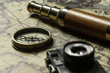 Retro compass with old map and spyglass