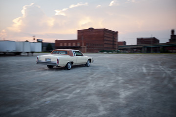 Blurry vintage car drifting in industrial depot