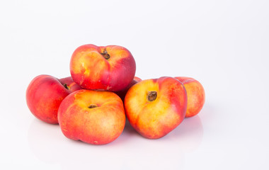 flat peaches (donut peaches) on a background