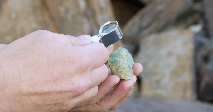 Close up look at mineral fluorite with loope hand lens mining exploration 