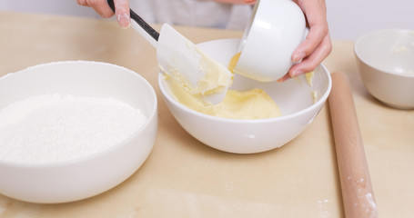 Female hands mixing dough
