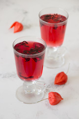 Red hibiscus tea in a glass cups on a table