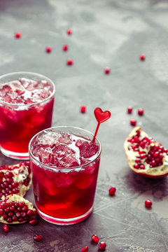 Pomegranat juice with ice and fruit slices, copy space