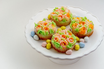 Top view decorated cupcakes with Easter eggs on white Background.
