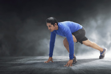 Muscular asian man ready for run