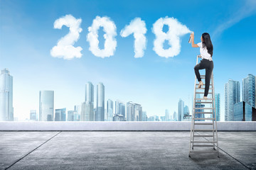 Business woman using stair spraying white cloud with 2018 shape