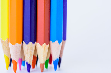 Closeup different colored pencils on white background.