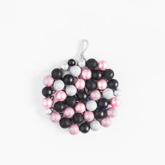 Christmas ball made of black, silver and pink balls on white background. Christmas, winter, new year concept. Top view, flat lay, square