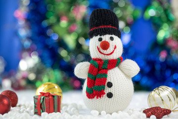 Snowman Standing with Gift Box on bokeh background. Christman Concept.