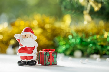 Santa claus Standing with Gift Box on bokeh background. Christman Concept.