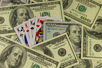 Playing cards on the American one hundred dollar bills background
