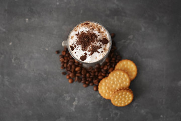 Glass with latte macchiato on grey background