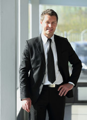 portrait of confident businessman on blurred background